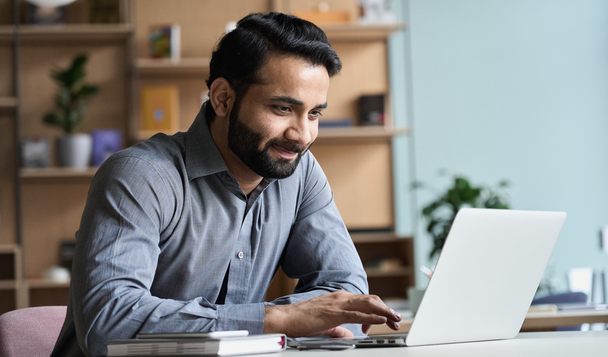 man smiling at laptop websites for dentists user friendly website