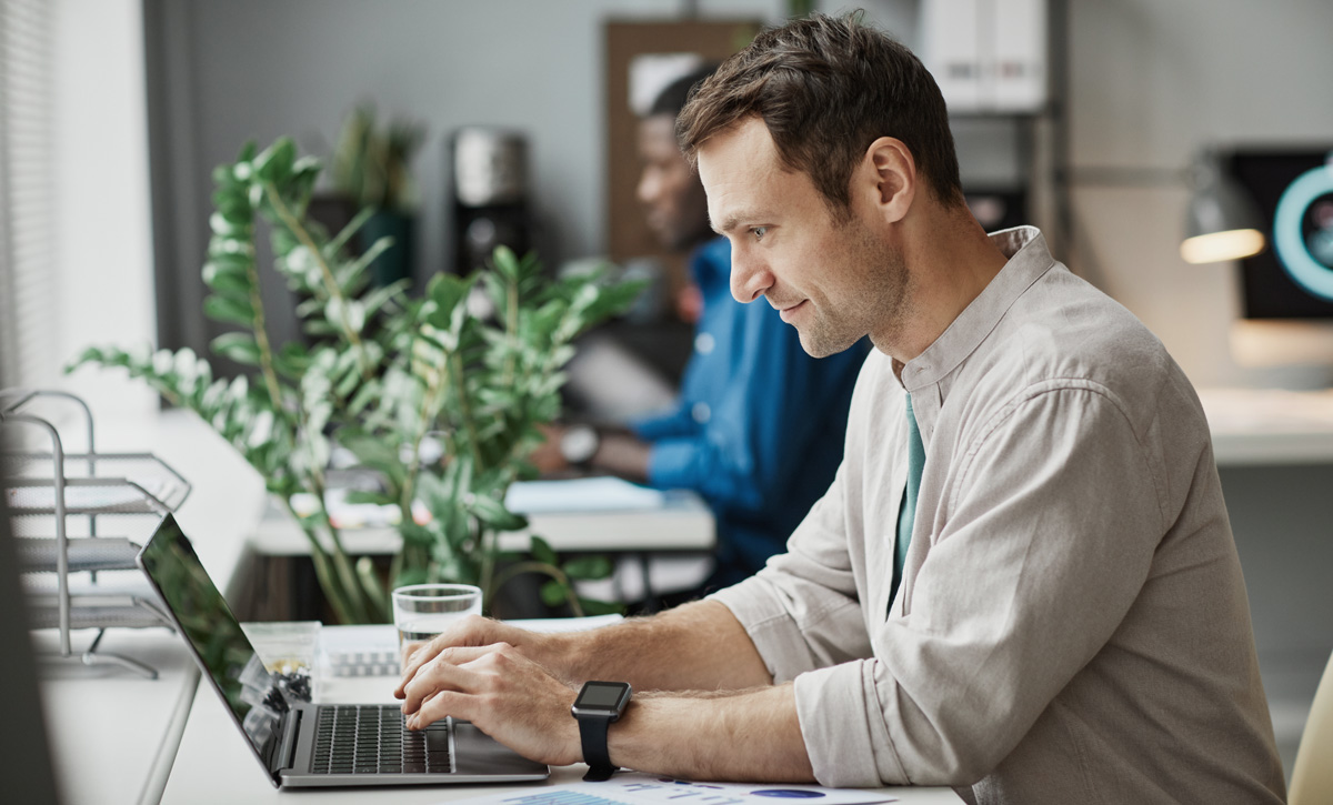 man looking at laptop dentist web design crafting content