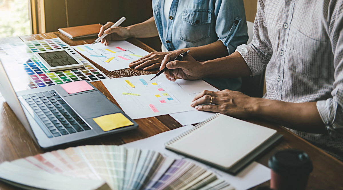 people working at laptop dentist web design kay design elements