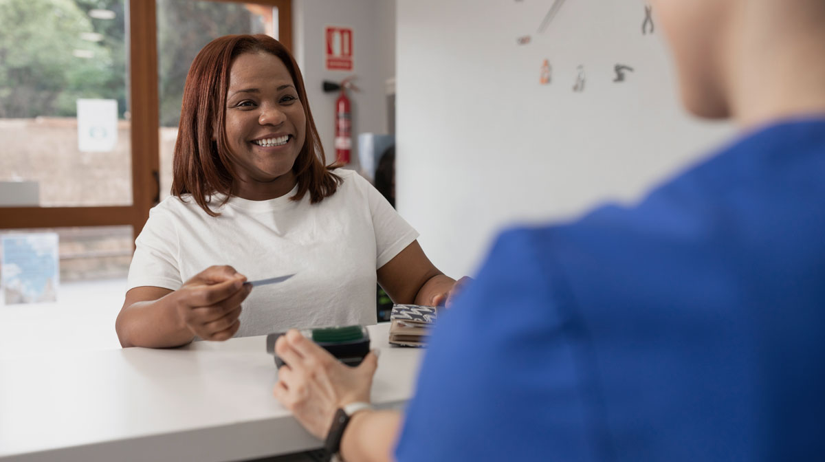 woman at dental reception after optimising dental website for local seo for dentists