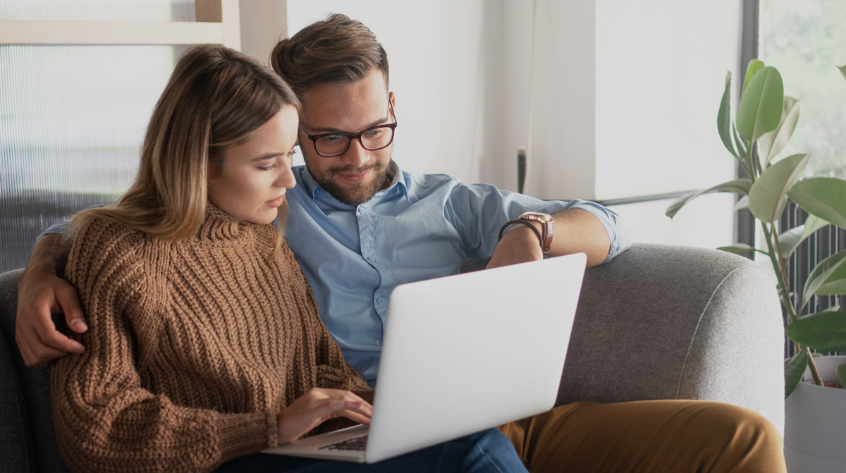 couple looking at laptop dental clinic website design booking