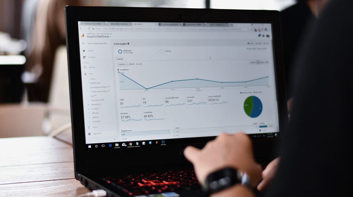 laptop with website statistics on screen monitoring performance with strategies of marketing