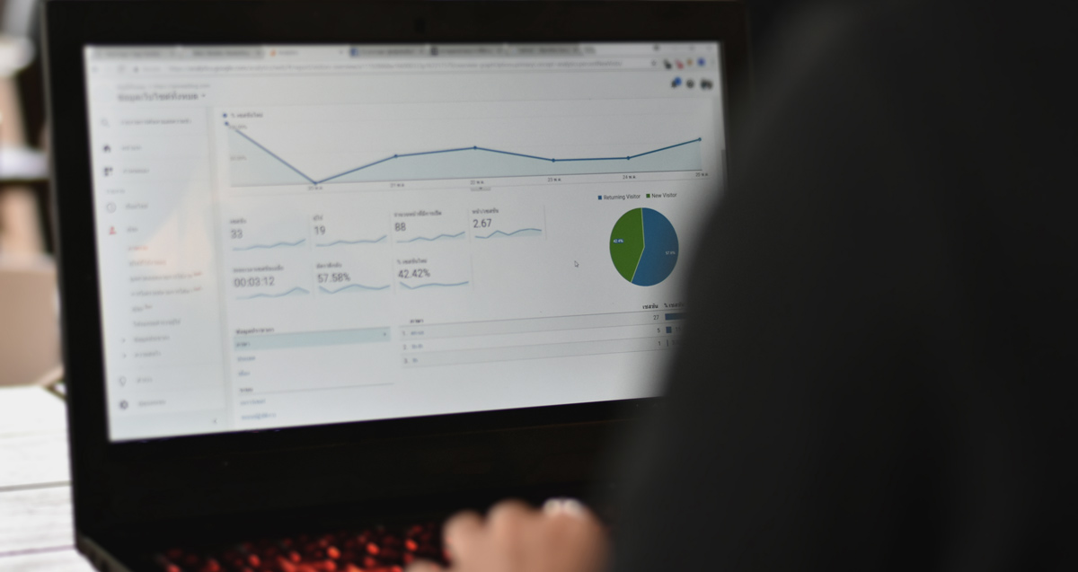 man looking at statistics on laptop to find ranking google keyword