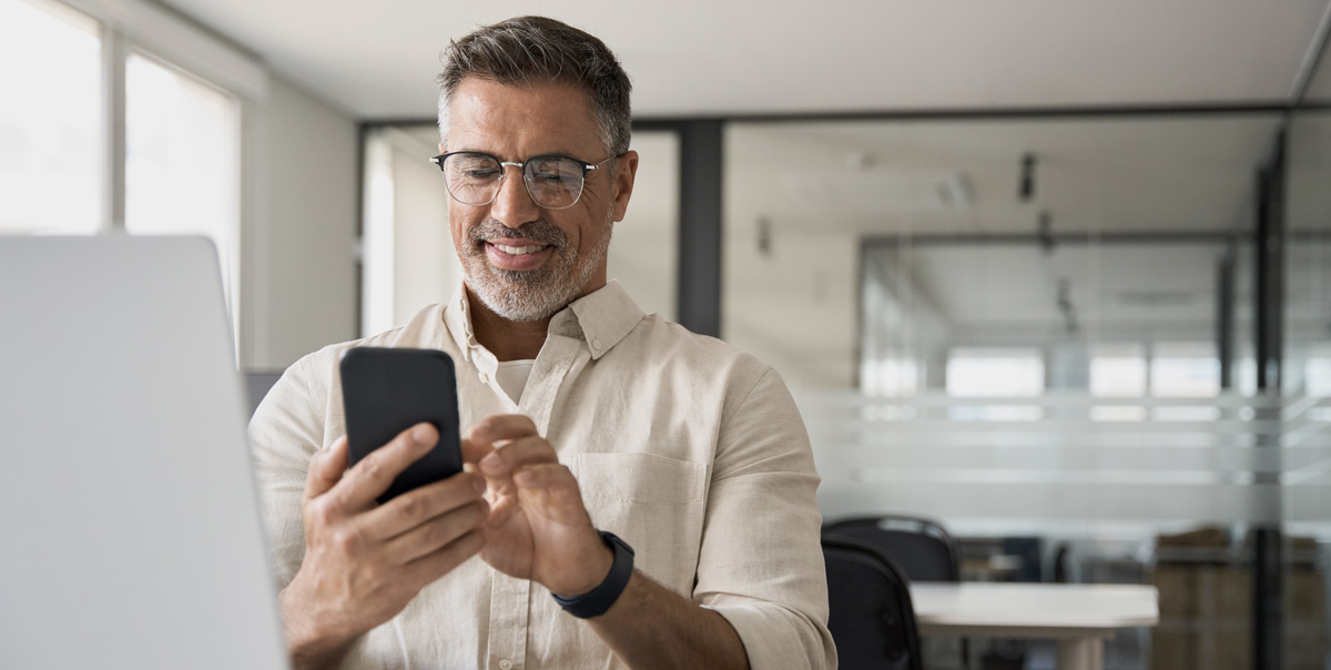 man smiling at phone user experience of dental clinic website design