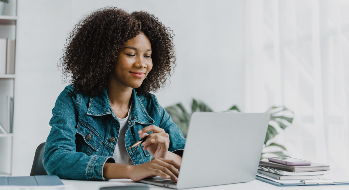 woman looking at laptop for dental clinic website design and content