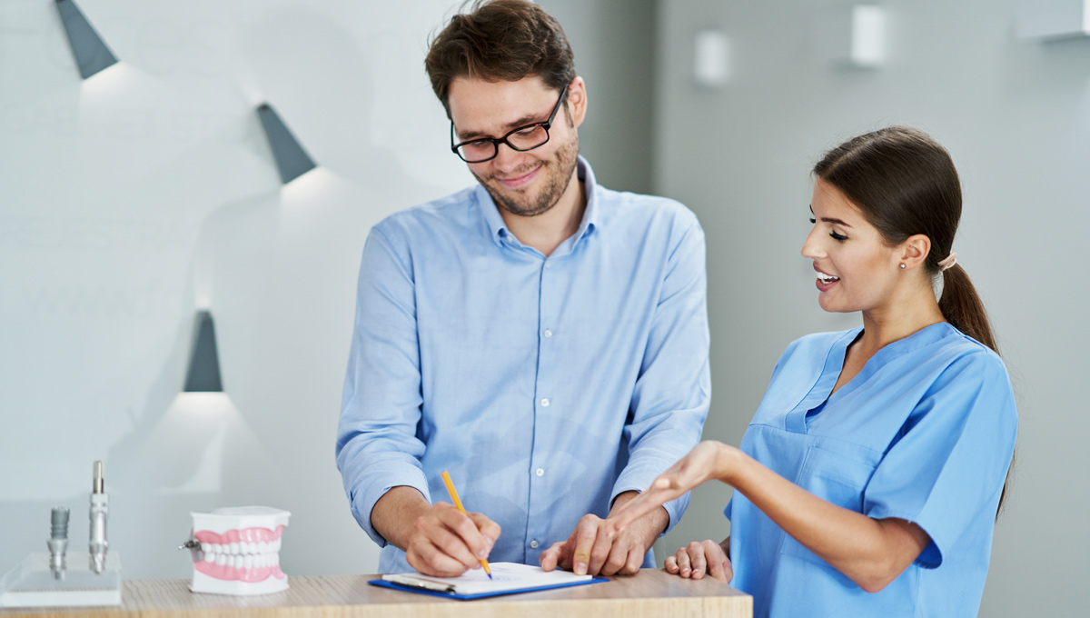 man at dentists reception website design for dentists improving visibility with local SEO