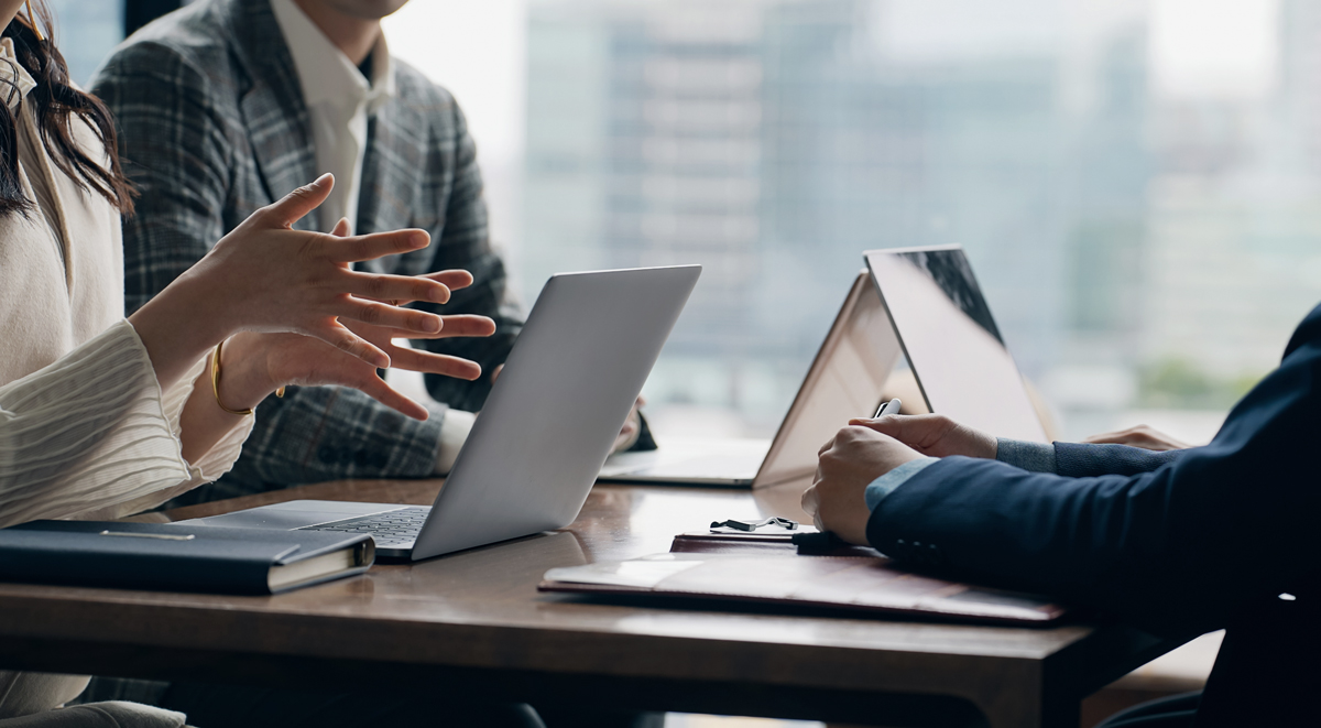 people sat talking in meeting aboput practical preperations for 2026 in seo for dentists