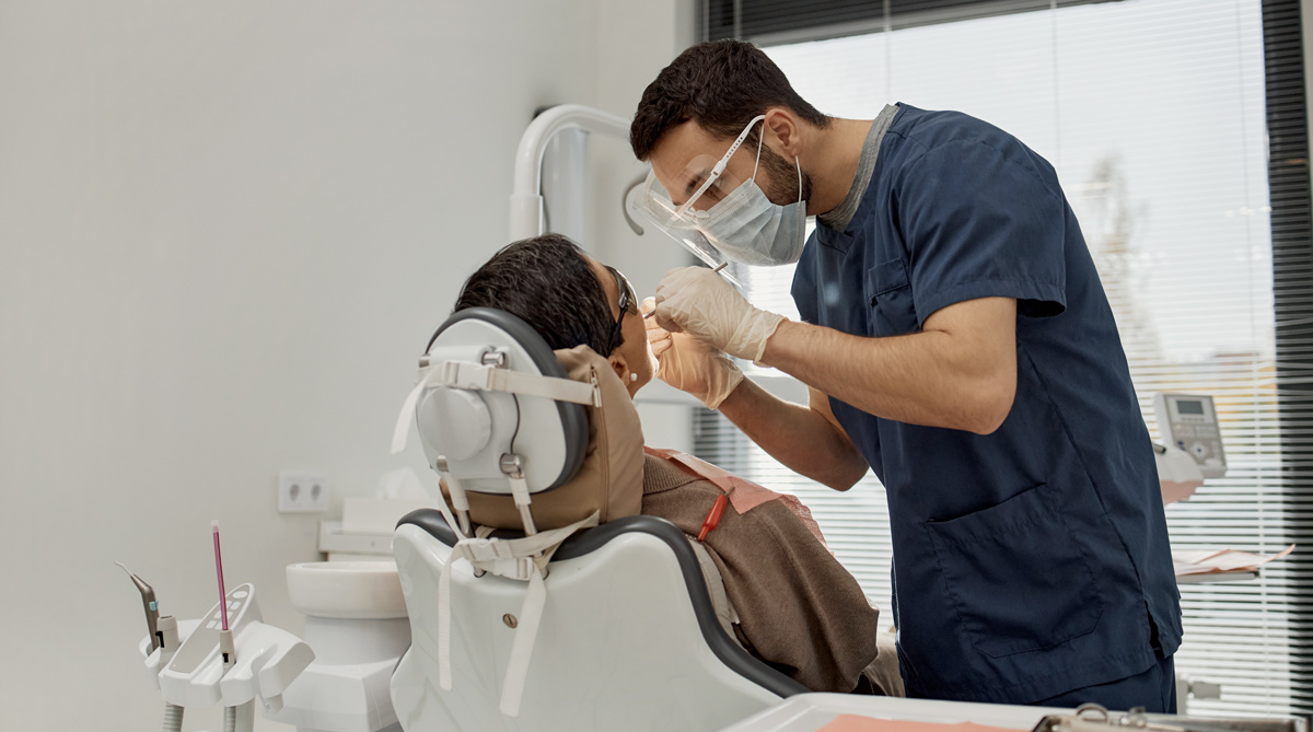 person sat in dentists chair showcasing treatment for web design for dentists