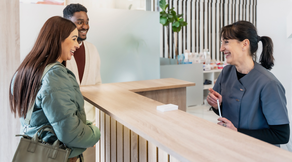 people at dental reception and what SEO for dental means