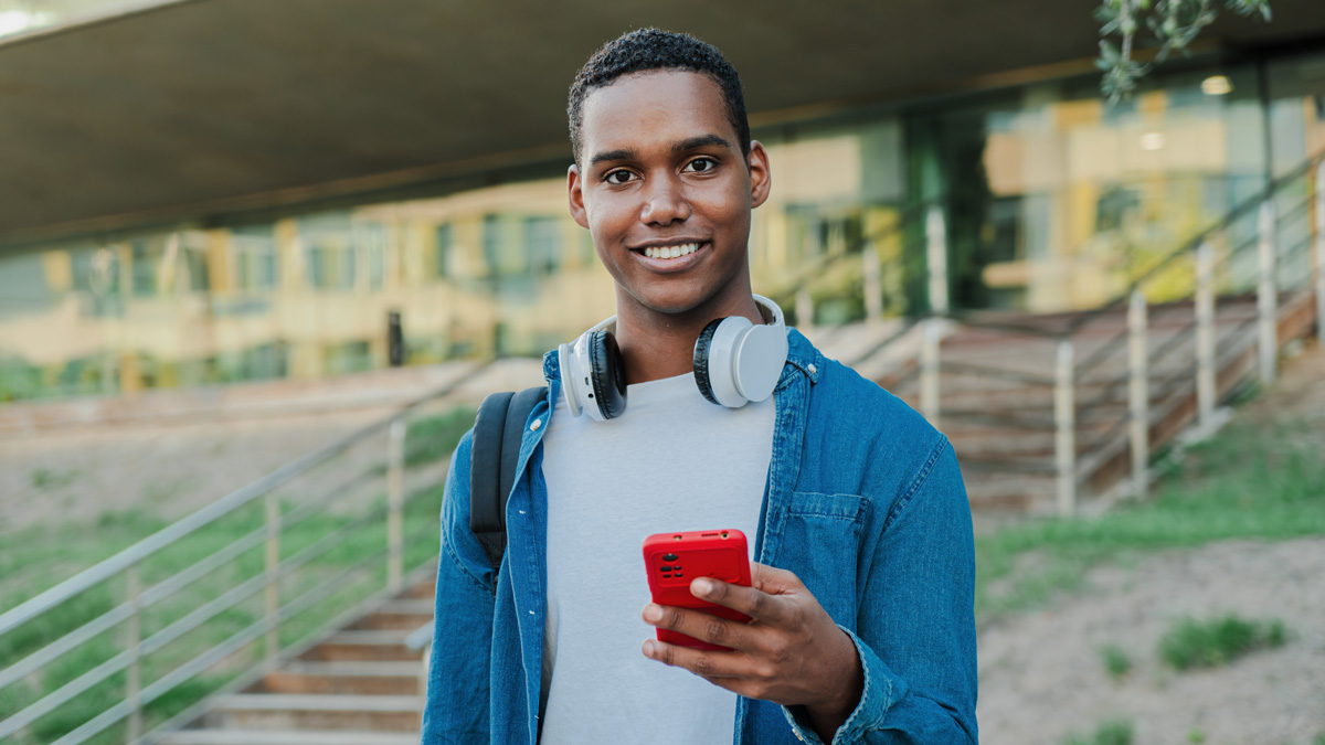 man smiling looking at phone in hand, optimised dental websites for user experience