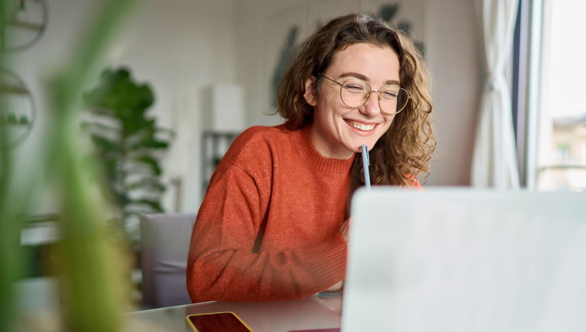 woman smiling at laptop Protect Your Job From AI Automation